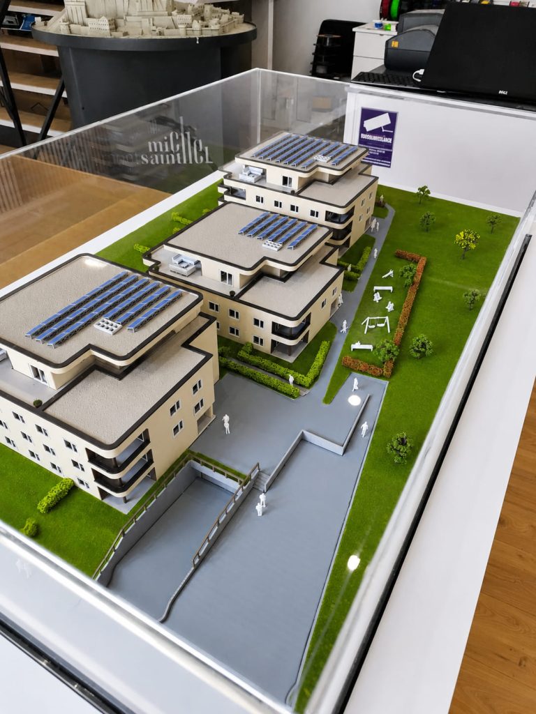 Maquette immobilière résidentielle sur mesure avec bâtiments, espaces verts et capot transparent